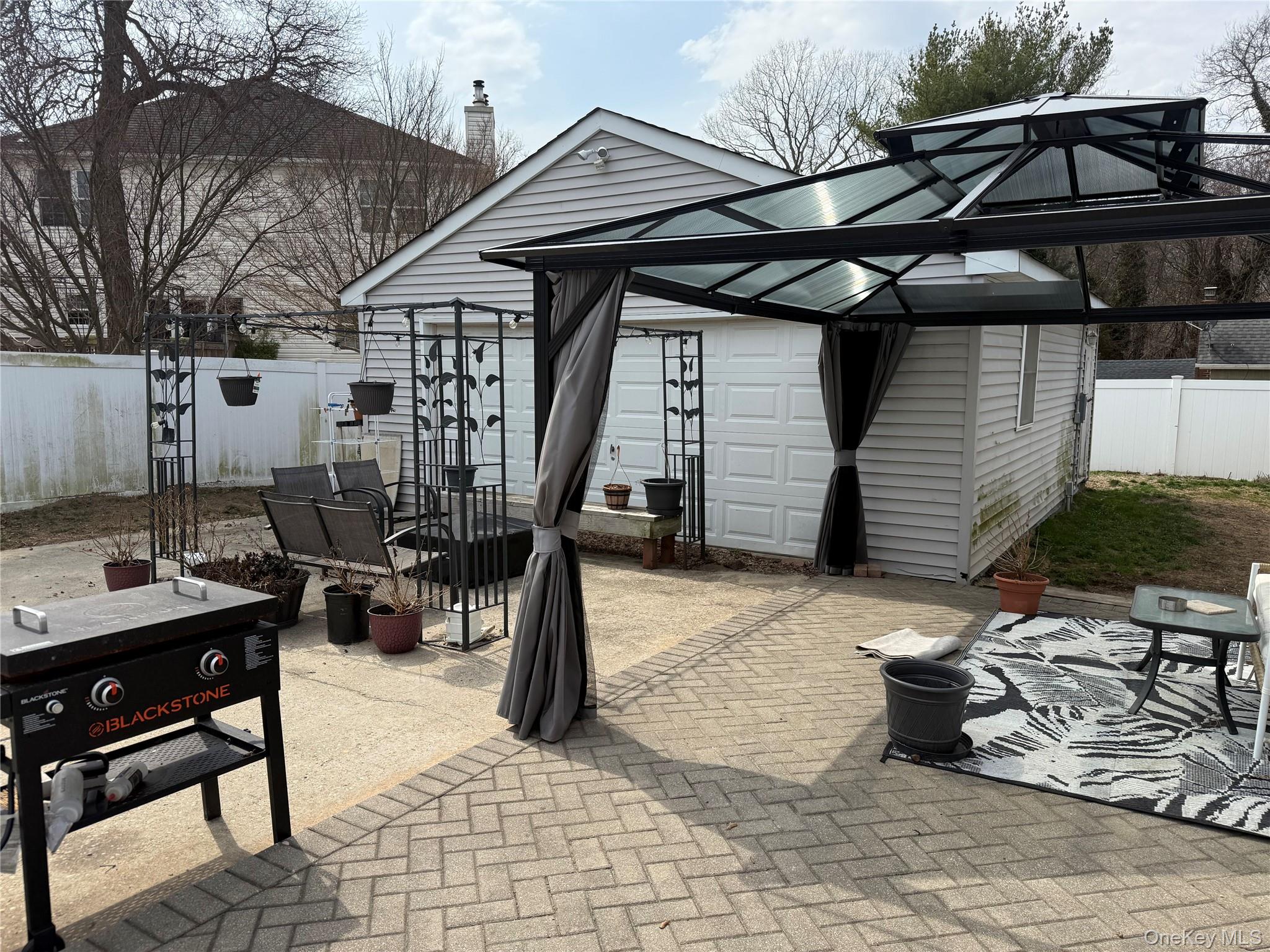 2 1st Street Coram, NY 11727 - Photo 7 of 36 a backyard of a house with barbeque oven table and chairs