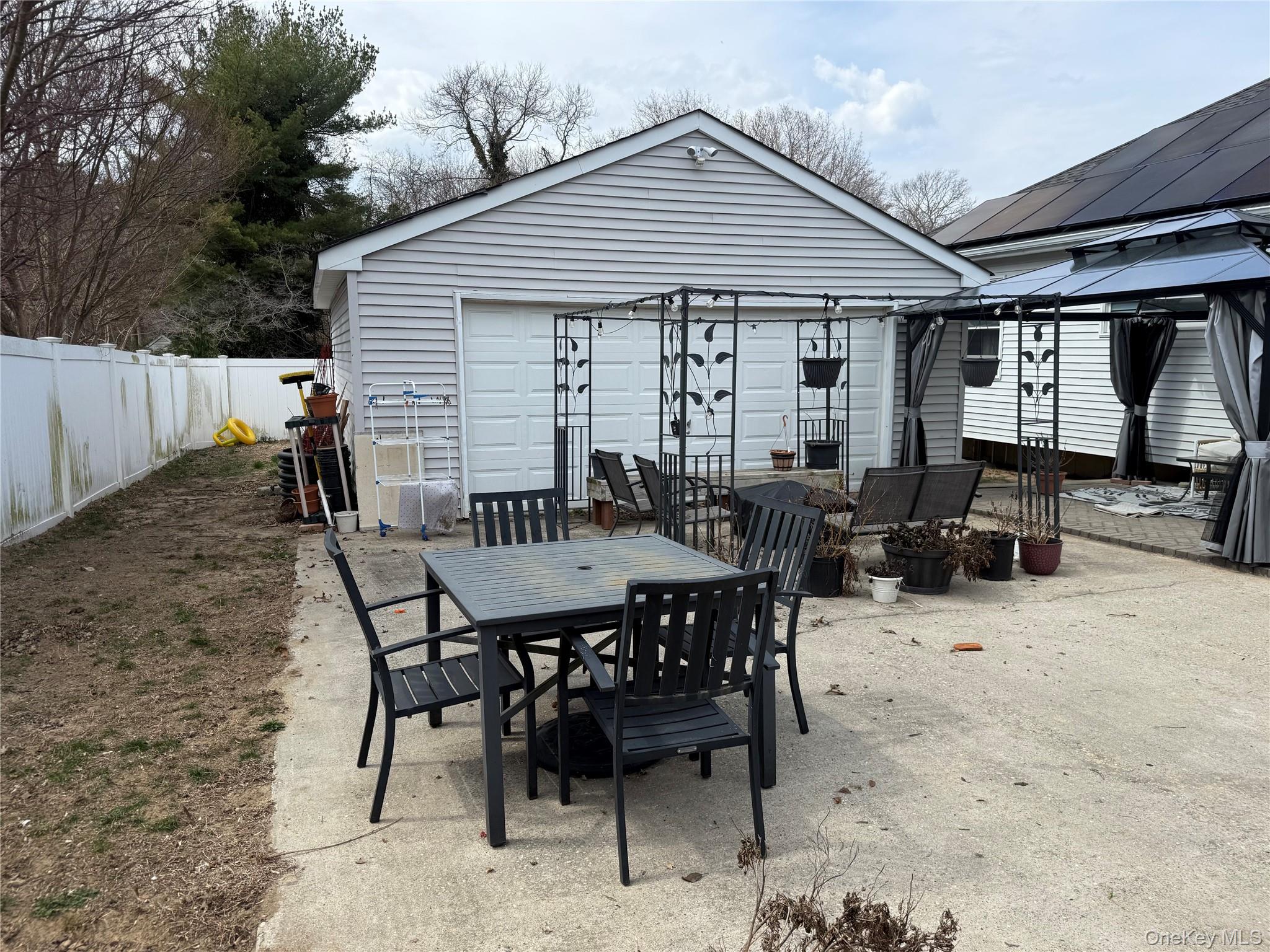 2 1st Street Coram, NY 11727 - Photo 9 of 36 a view of a patio with a dining table and chairs