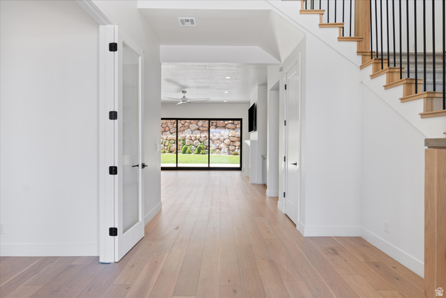 1192 East Corral Way Washington, UT 84780 - Photo 9 of 81 Entryway featuring wood-finish flooring, a contemporary staircase with black metal balusters, and frosted glass panel interior doors