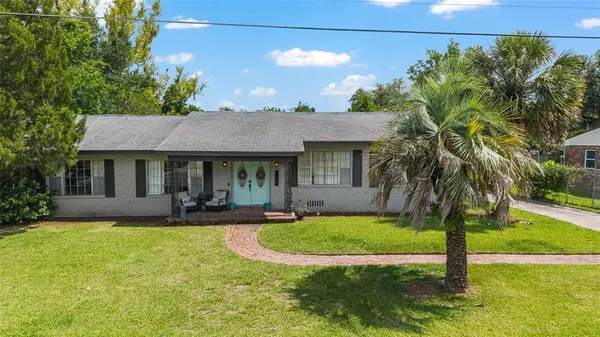 a front view of a house with garden and porch
