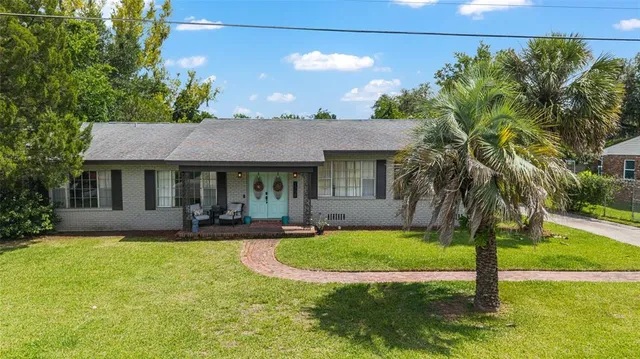 a front view of a house with garden and porch