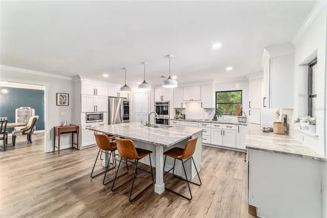 a view of a dining room with furniture and wooden floor