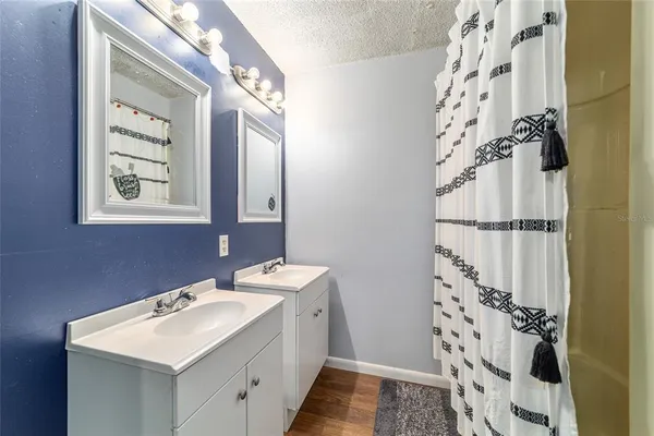 a bathroom with a sink mirror and a shower