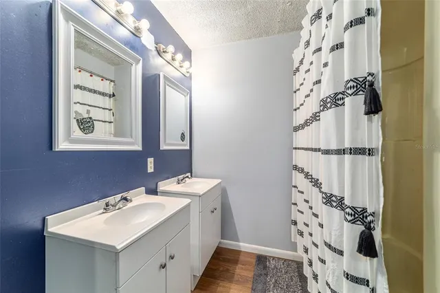 a bathroom with a sink mirror and a shower
