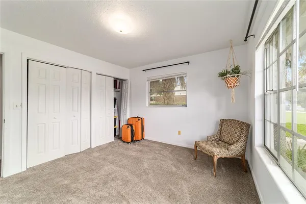 a bedroom with furniture and a window