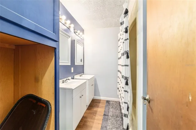 a bathroom with a sink a mirror and a shower