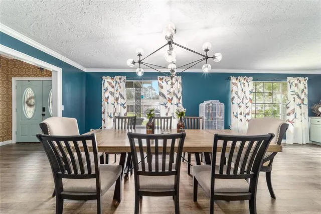 a view of a dining room and livingroom with furniture window and wooden floor