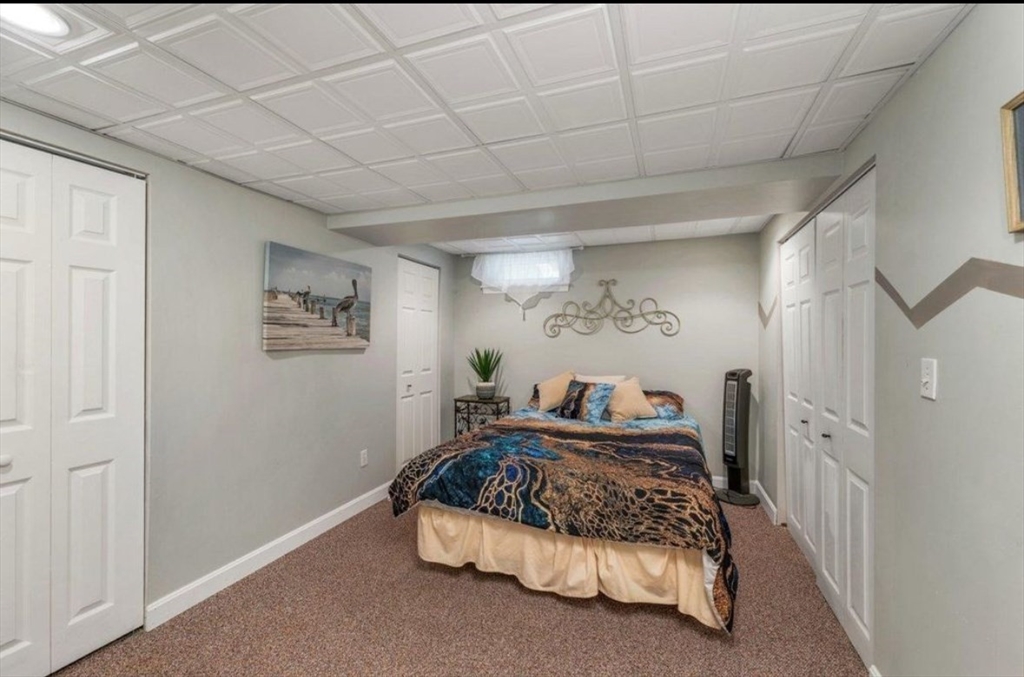 81 Salem Road, Unit 102 Billerica, MA 01821 - Photo 4 of 4 a bedroom with a bed and a painting on the wall