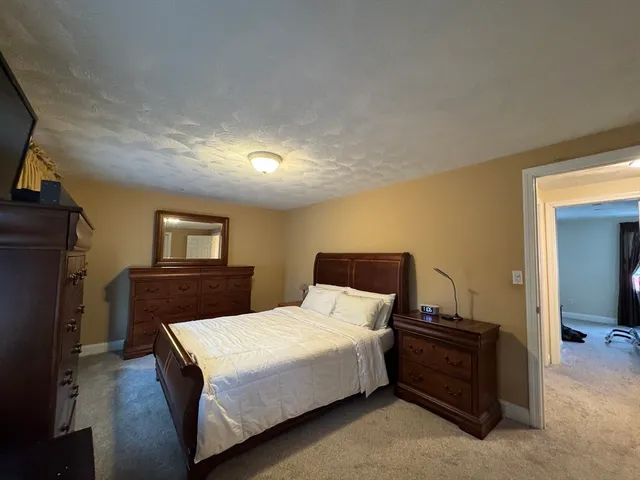 a bedroom with a bed and a night stand