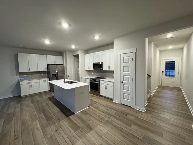 a large kitchen with cabinets and stainless steel appliances