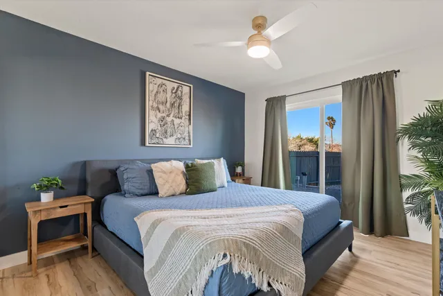 a bedroom with a large bed and a chandelier