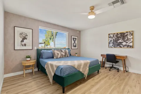 a bedroom with a bed and a desk