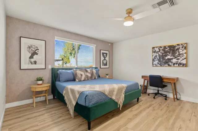 a bedroom with a bed and a desk