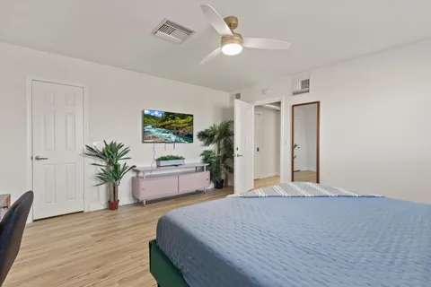 a bedroom with a large bed and a chandelier