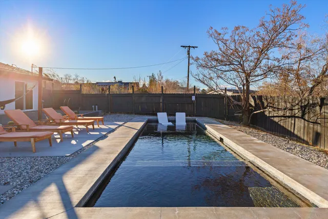 a view of a balcony with wooden floor and bench
