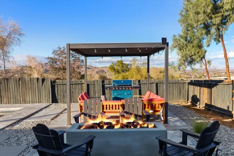 an outdoor seating area with furniture and city view
