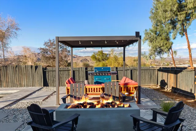 an outdoor seating area with furniture and city view