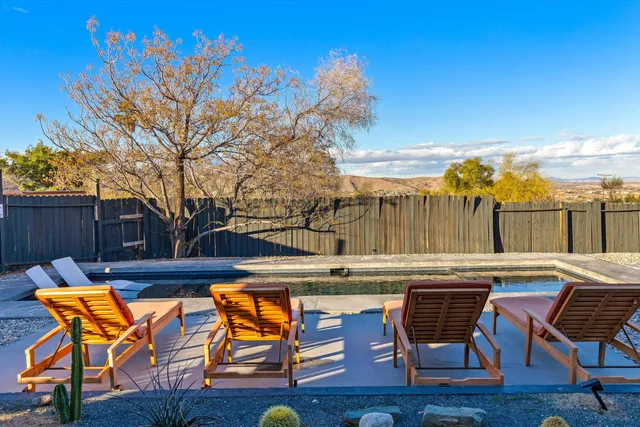 a view of a backyard with swimming area