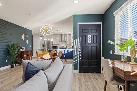 a living room with furniture and a chandelier
