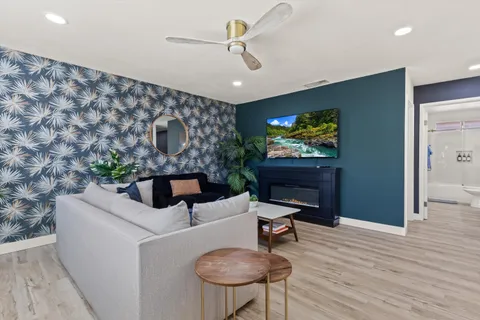 a living room with furniture and a chandelier