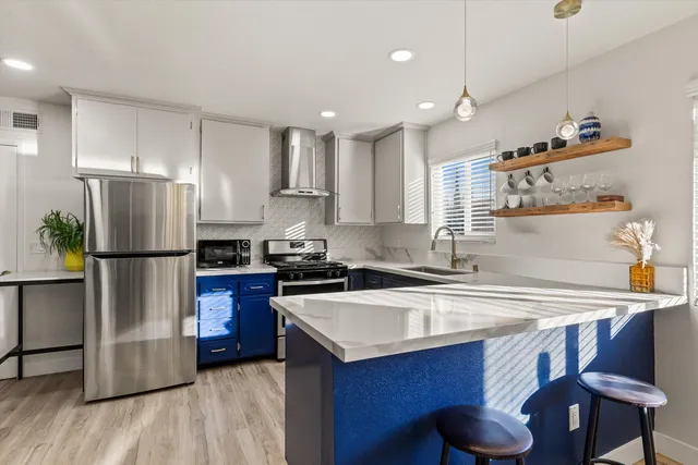 a kitchen with a sink a refrigerator and a stove