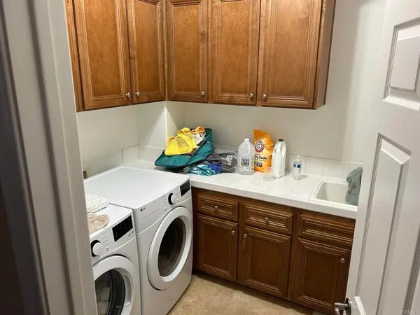 a bedroom with two beds and wooden floor