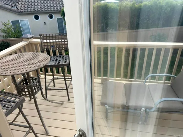 a view of a house with a yard and potted plants