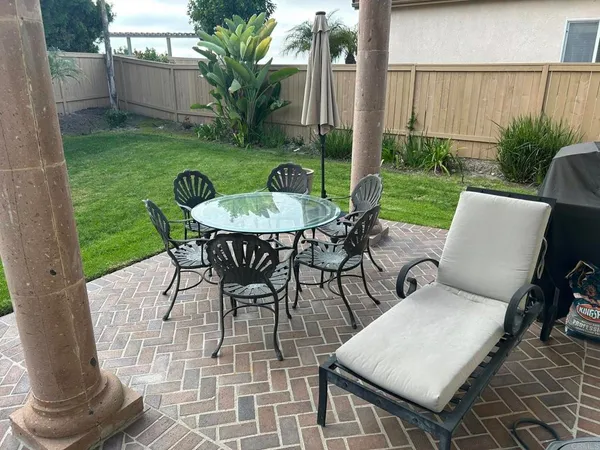 a view of an house with backyard porch and sitting area