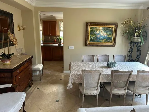 a kitchen with kitchen island granite countertop a sink a counter top space appliances and cabinets