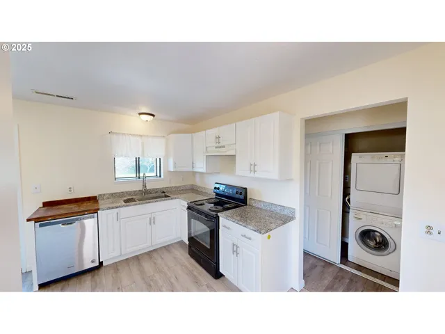 a open kitchen with sink and refrigerator