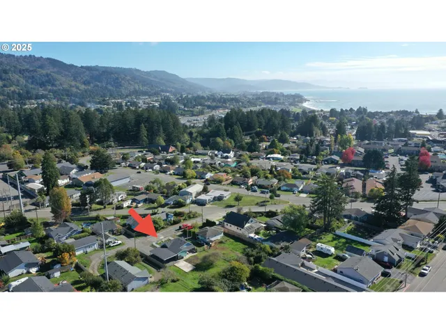 an aerial view of a house with a yard