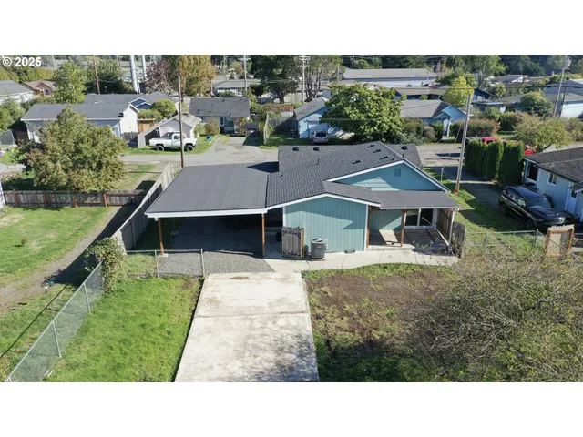 a view of a house with backyard porch and sitting area