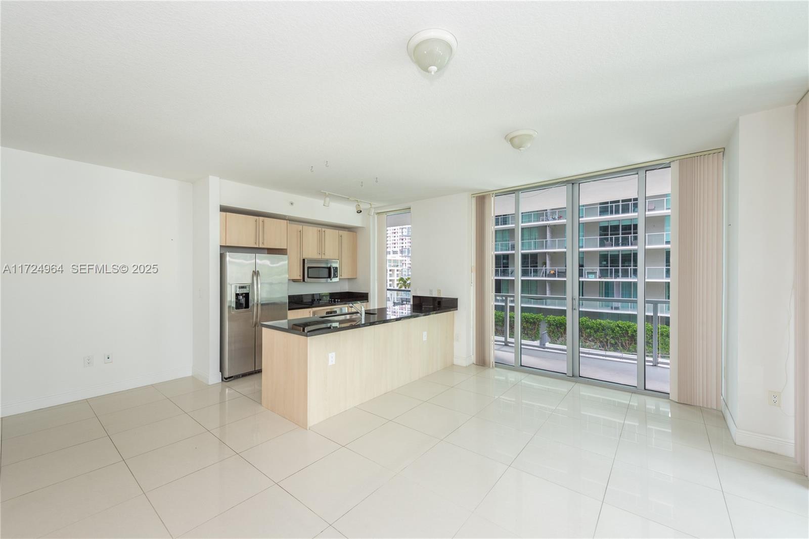79 Southwest 12th Street, Unit 1107S Miami, FL 33130 - Photo 5 of 26 a large white kitchen with cabinets and a stove