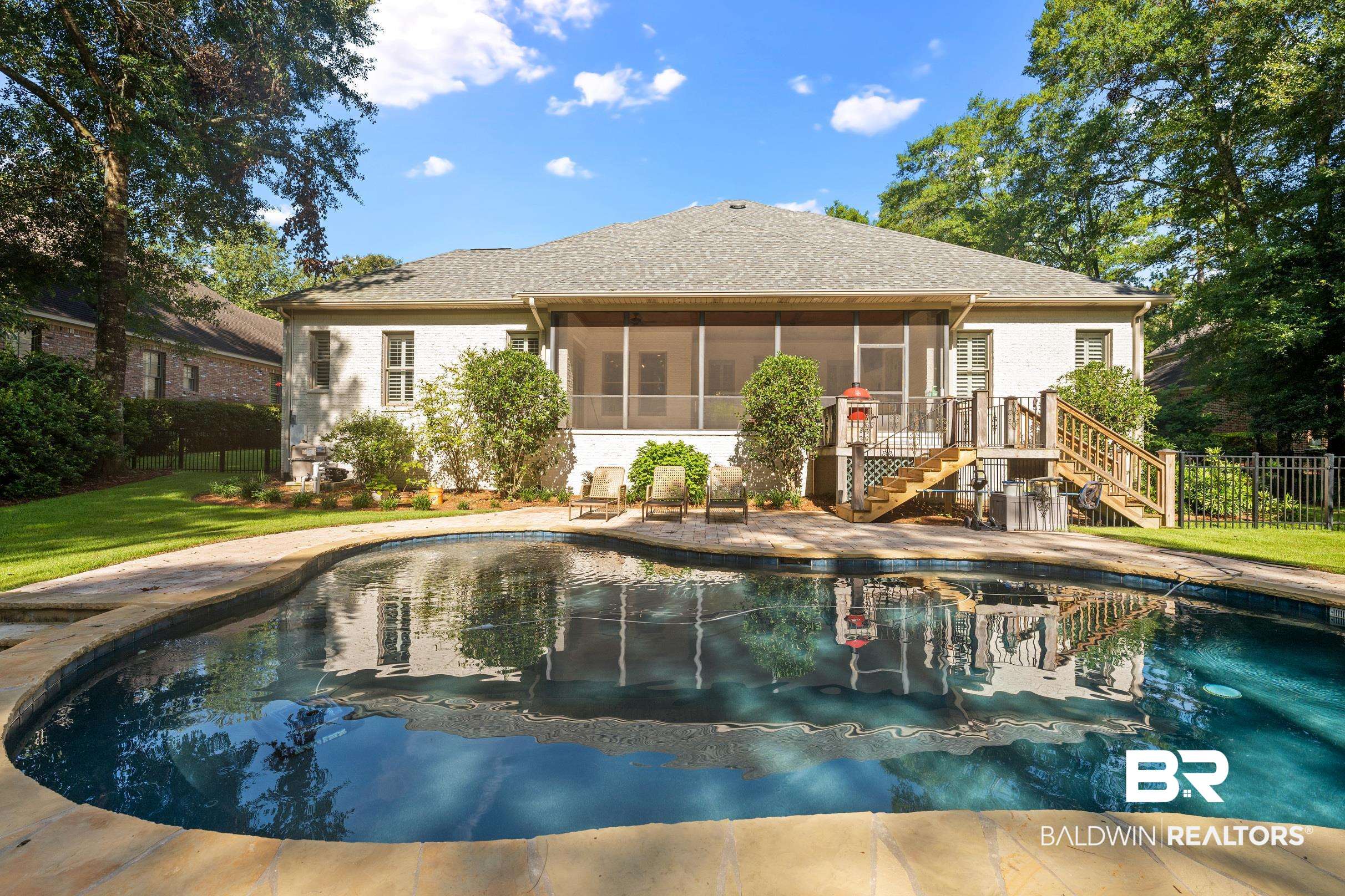 115 Sandy Ford Road Fairhope, AL 36532 - Photo 2 of 47 Rear view of house featuring stairway, a sunroom, and stucco siding