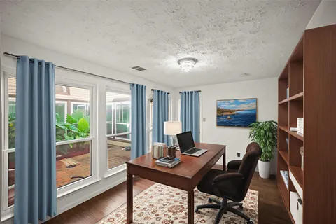 a view of a livingroom with furniture and a potted plant