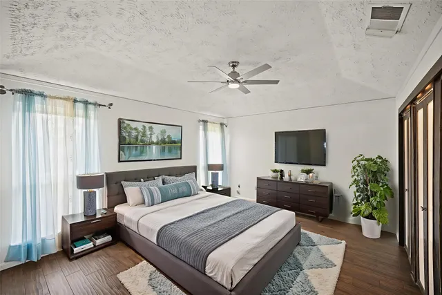 a bedroom with a bed and a flat screen tv