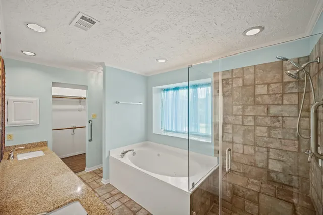 a bathroom with a bathtub and a shower