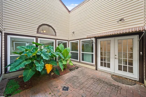 a front view of a house with a garden
