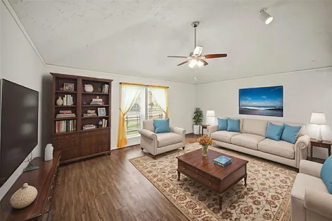 a living room with furniture a rug and a flat screen tv