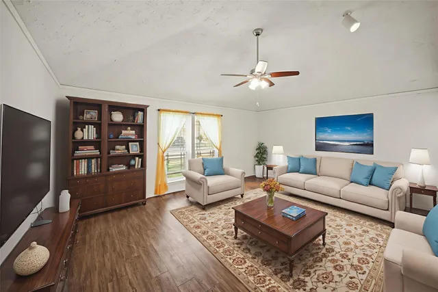 a living room with furniture a rug and a flat screen tv