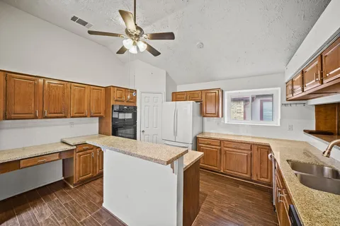 a kitchen that has a sink and a stove