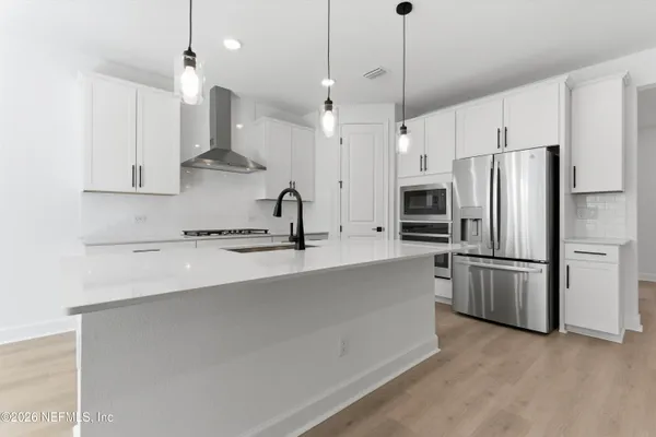 a kitchen with stainless steel appliances a refrigerator and a sink