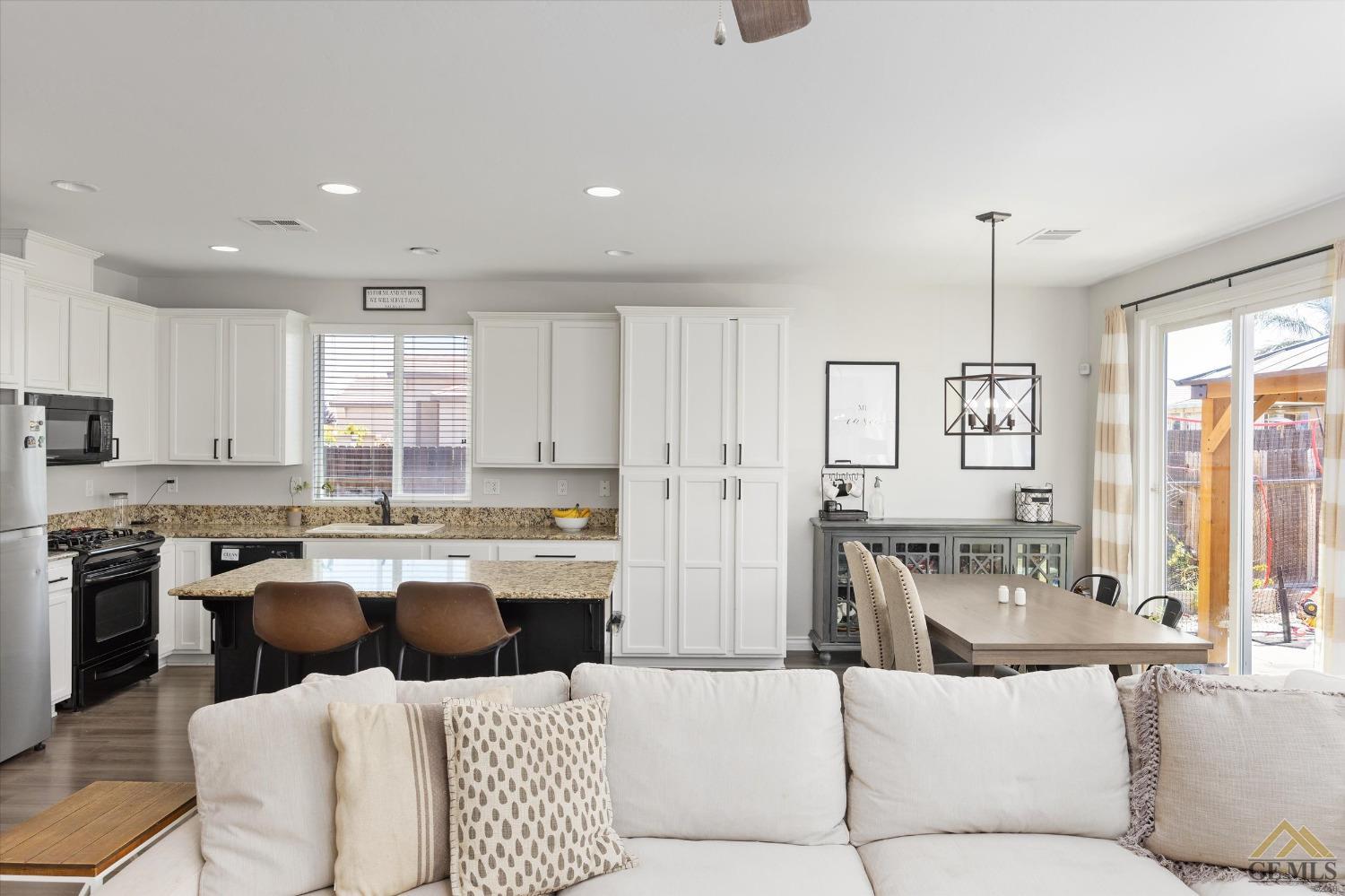 Undisclosed Address Bakersfield, CA 93314 - Photo 11 of 28 a living room with stainless steel appliances kitchen island granite countertop furniture and a view of kitchen