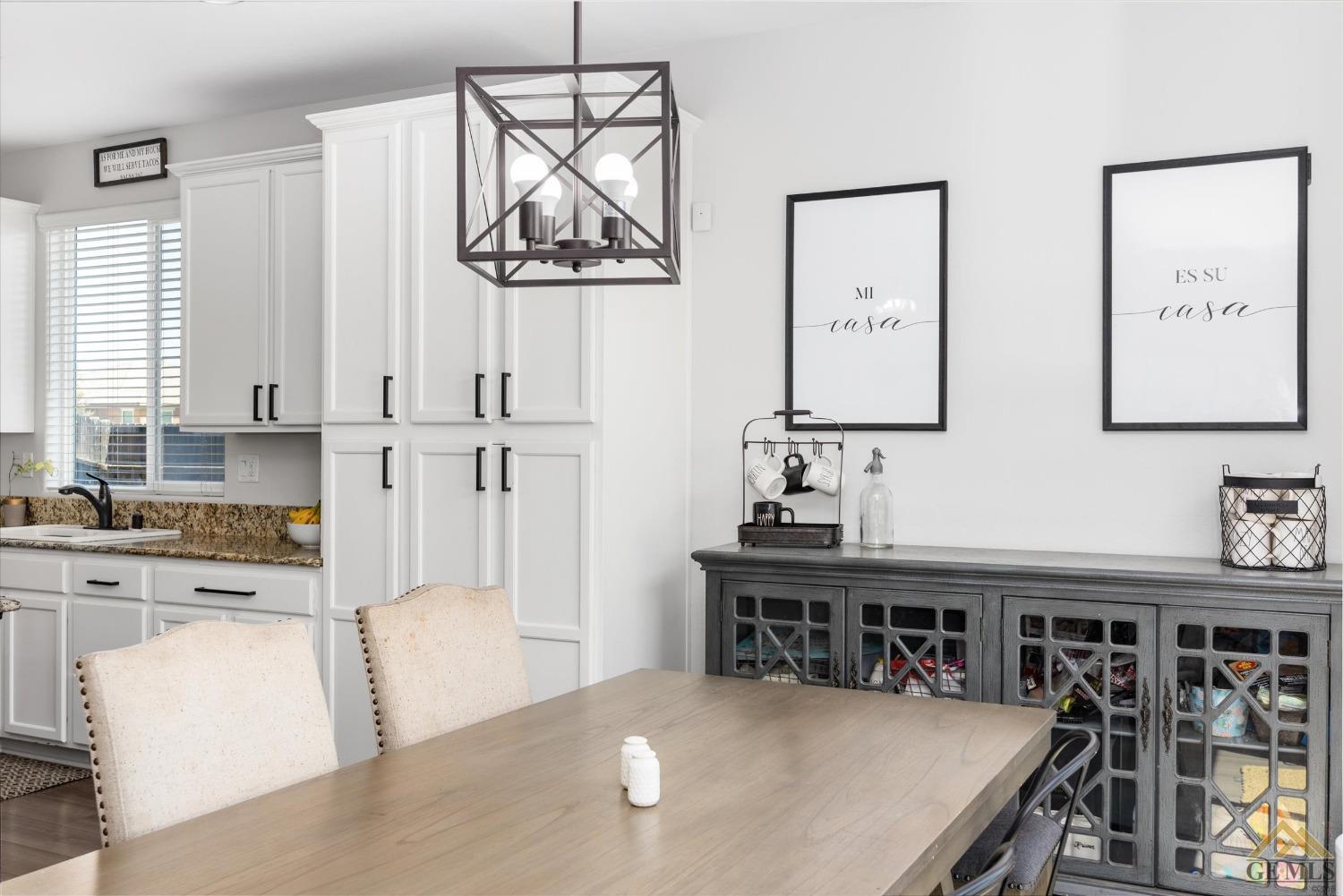 Undisclosed Address Bakersfield, CA 93314 - Photo 12 of 28 a kitchen with stainless steel appliances a white table chairs and a refrigerator