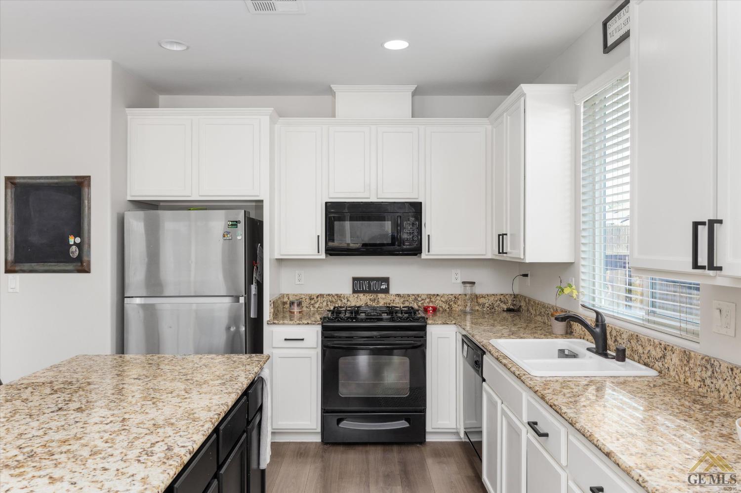 Undisclosed Address Bakersfield, CA 93314 - Photo 14 of 28 a kitchen with a sink stove and refrigerator