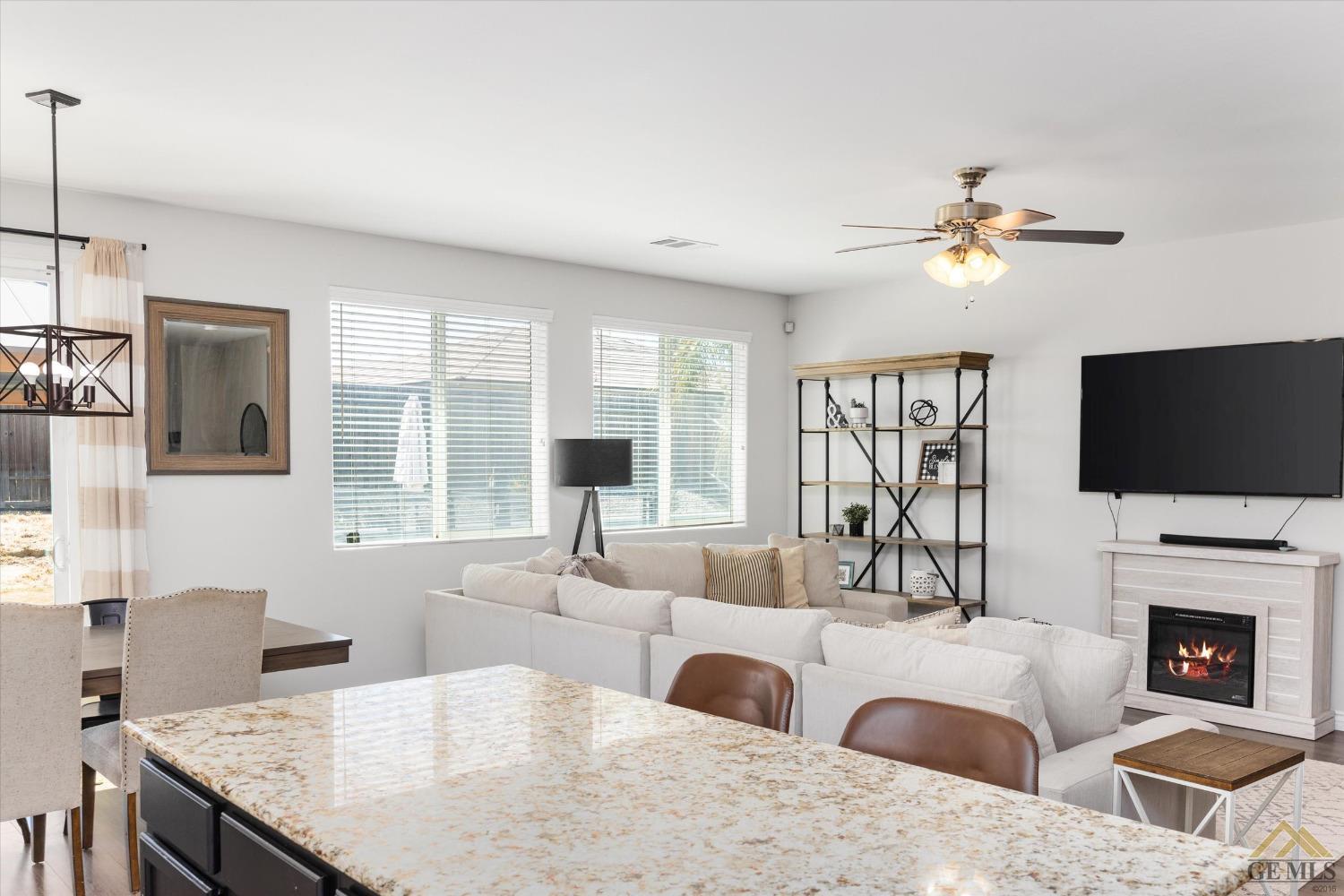 Undisclosed Address Bakersfield, CA 93314 - Photo 15 of 28 a living room with fireplace furniture and a flat screen tv