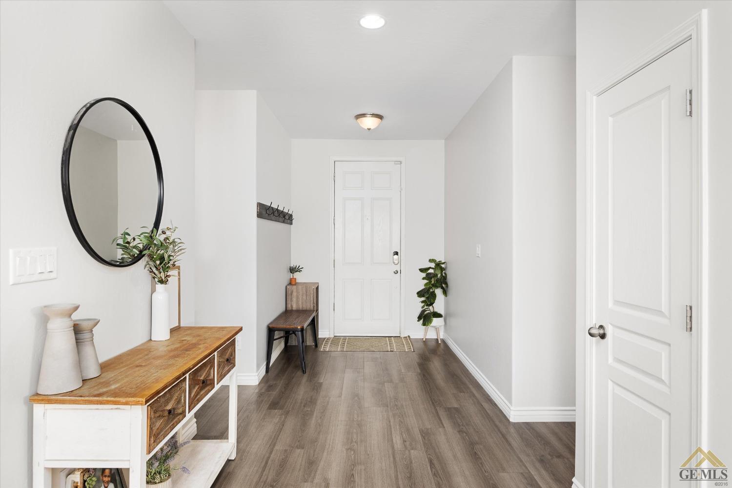 Undisclosed Address Bakersfield, CA 93314 - Photo 16 of 28 a view of a room with wooden floor and staircase