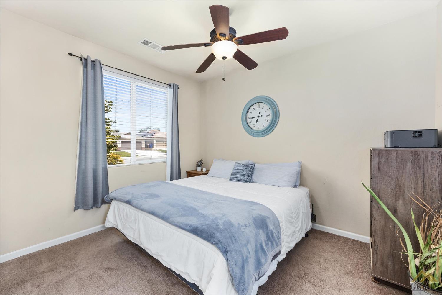 Undisclosed Address Bakersfield, CA 93314 - Photo 20 of 28 a bedroom with a bed and a chandelier