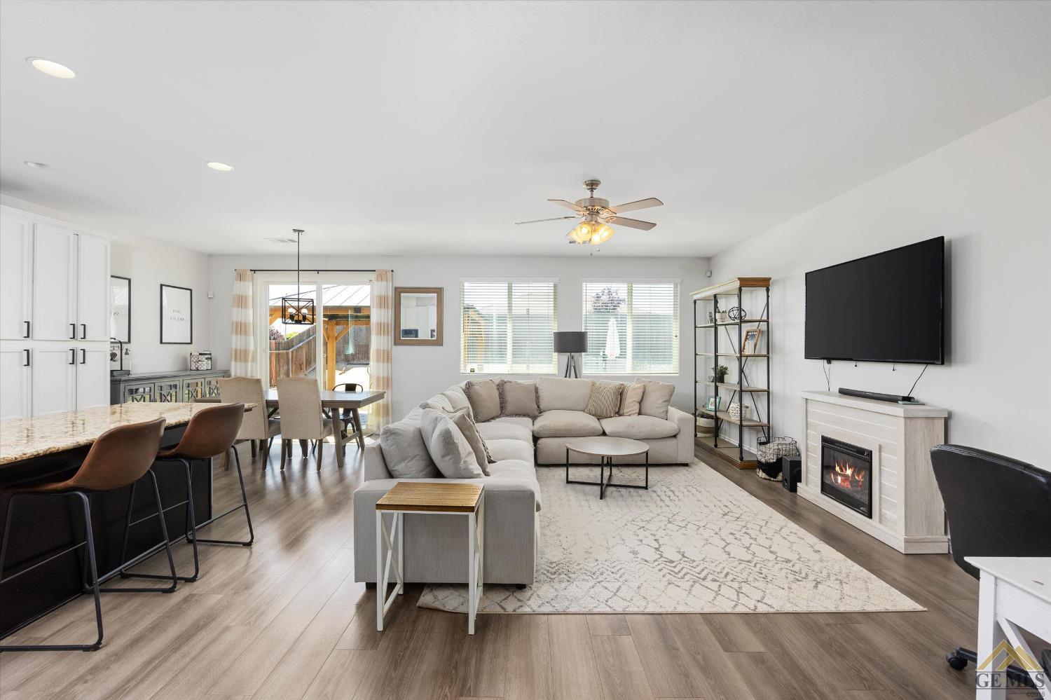 Undisclosed Address Bakersfield, CA 93314 - Photo 7 of 28 a living room with furniture and a flat screen tv