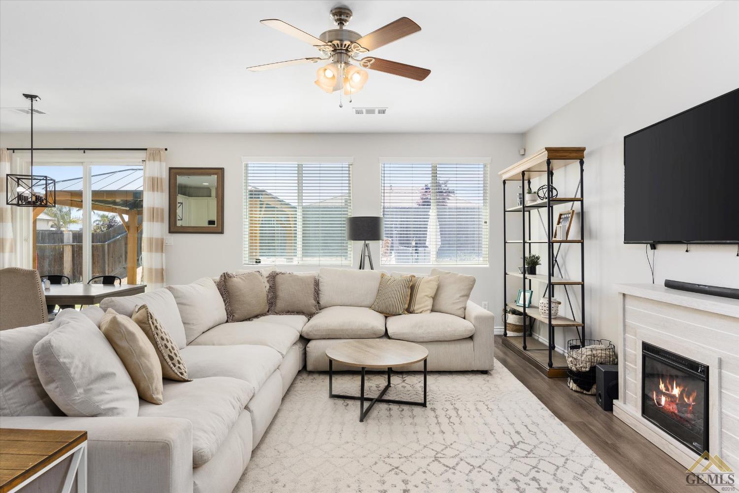 Undisclosed Address Bakersfield, CA 93314 - Photo 8 of 28 a living room with furniture a flat screen tv and a fireplace